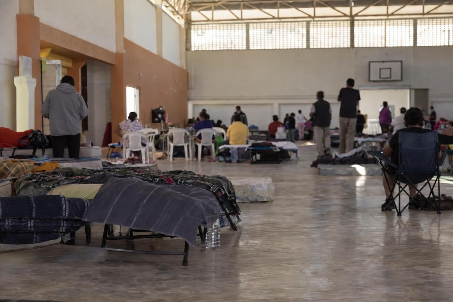 Anonymous residents gathered inside an emergency shelter.