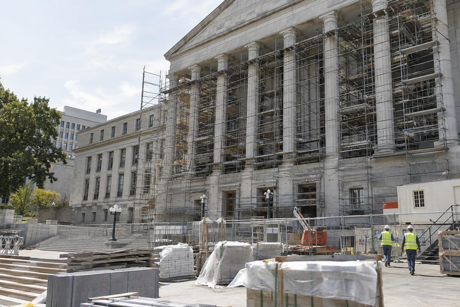 Exterior of a large government office building beside a renovation work area