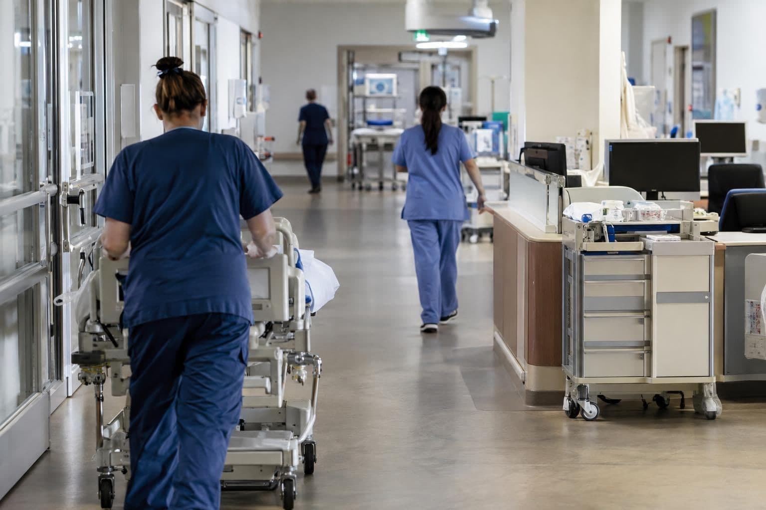 Anonymous health-care staff work in a clinical setting.