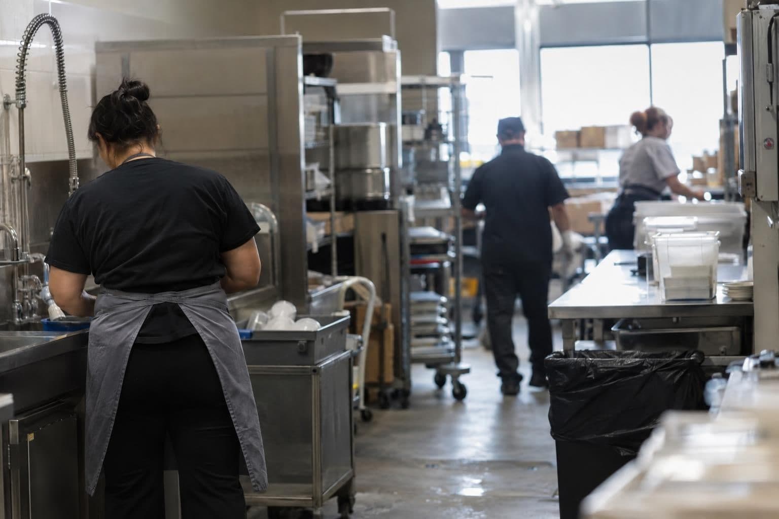Workers in a generic workplace, illustrating concerns about uncertain hours and job security.
