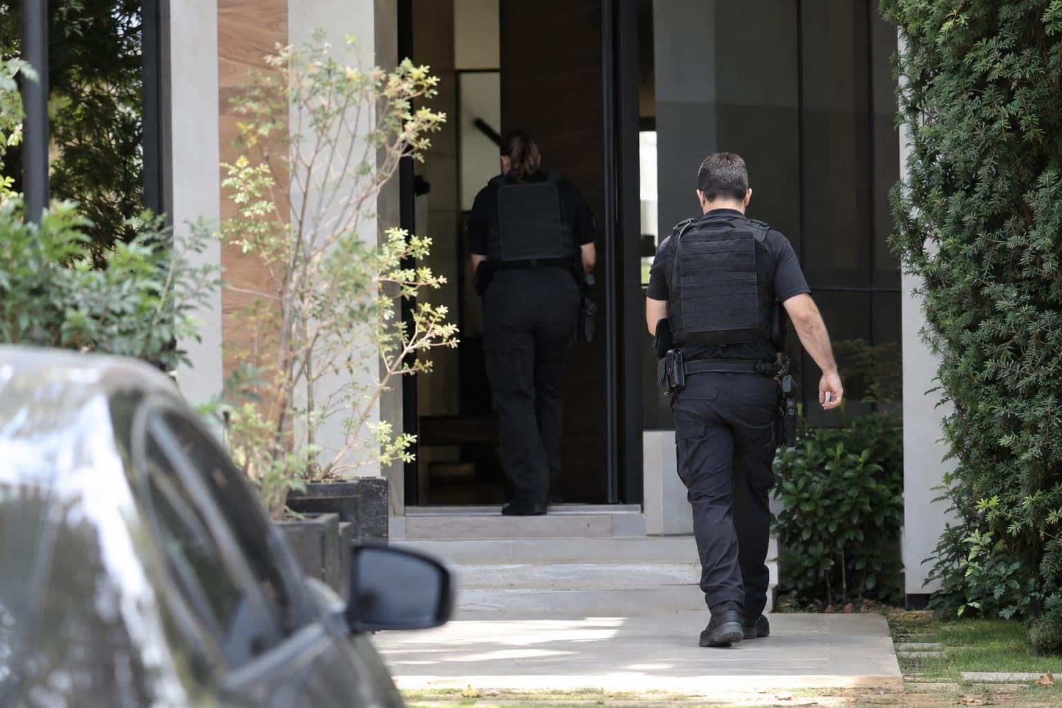 Federal Police officers conduct a search at an unidentified site in Brazil.