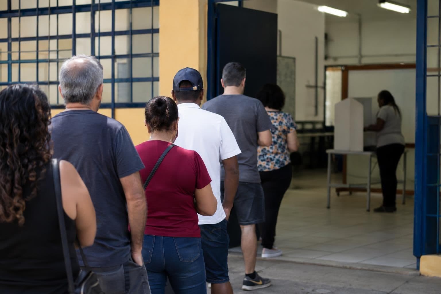 Voters wait at a polling station in Brazil during a general election.