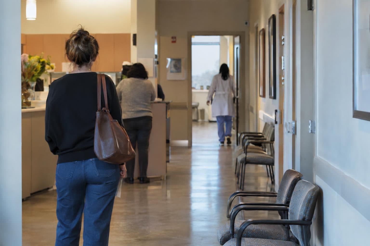 Anonymous adults in a care setting, representing people seeking abortion care under state policies.