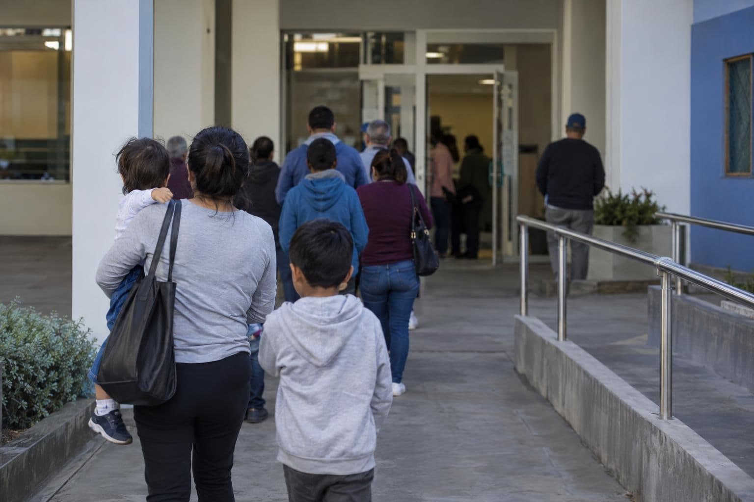 Anonymous residents at a public-service facility, illustrating pressure on social and development programs.
