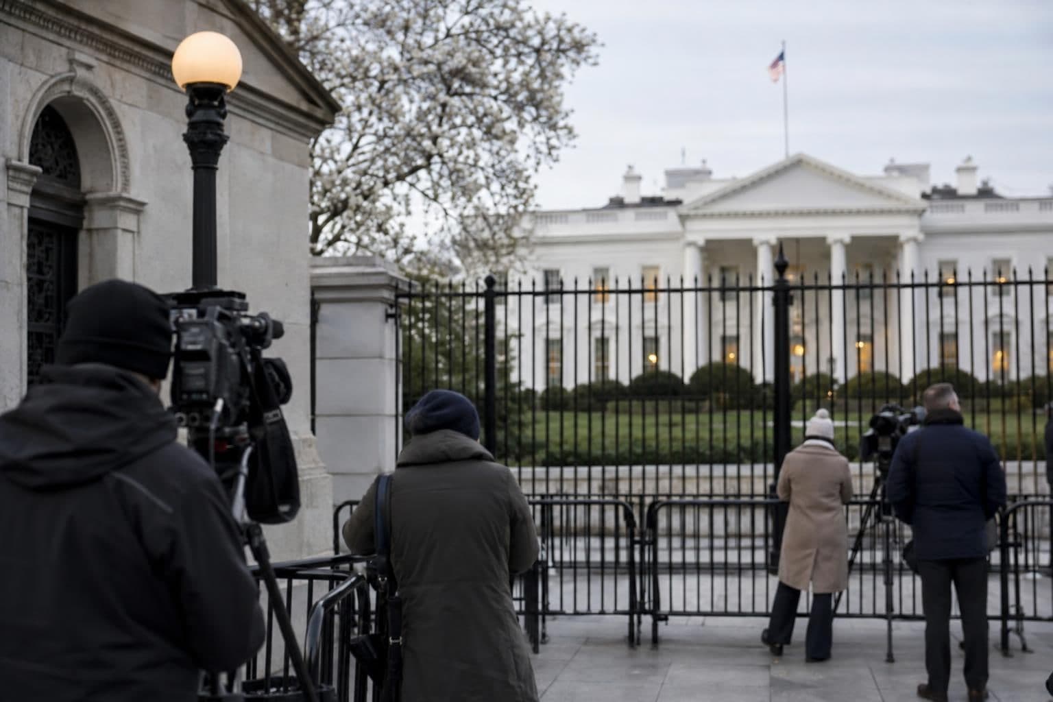Journalists outside the White House amid a dispute over press access.