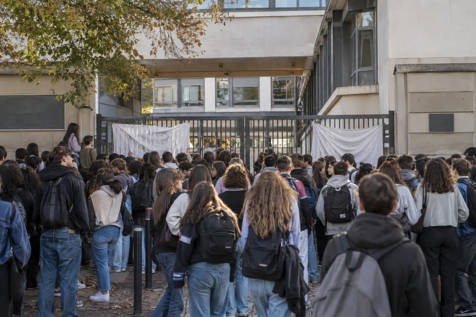 Students gather outside a French school during protests over staffing and learning conditions.