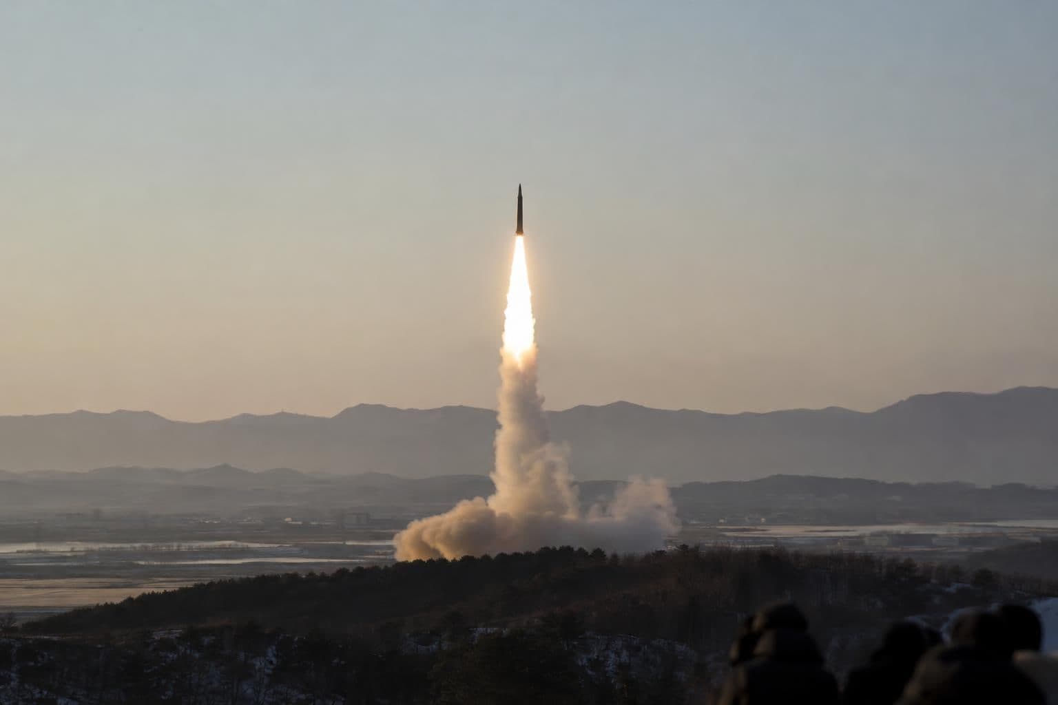 A ballistic missile lifts off in the morning sky.