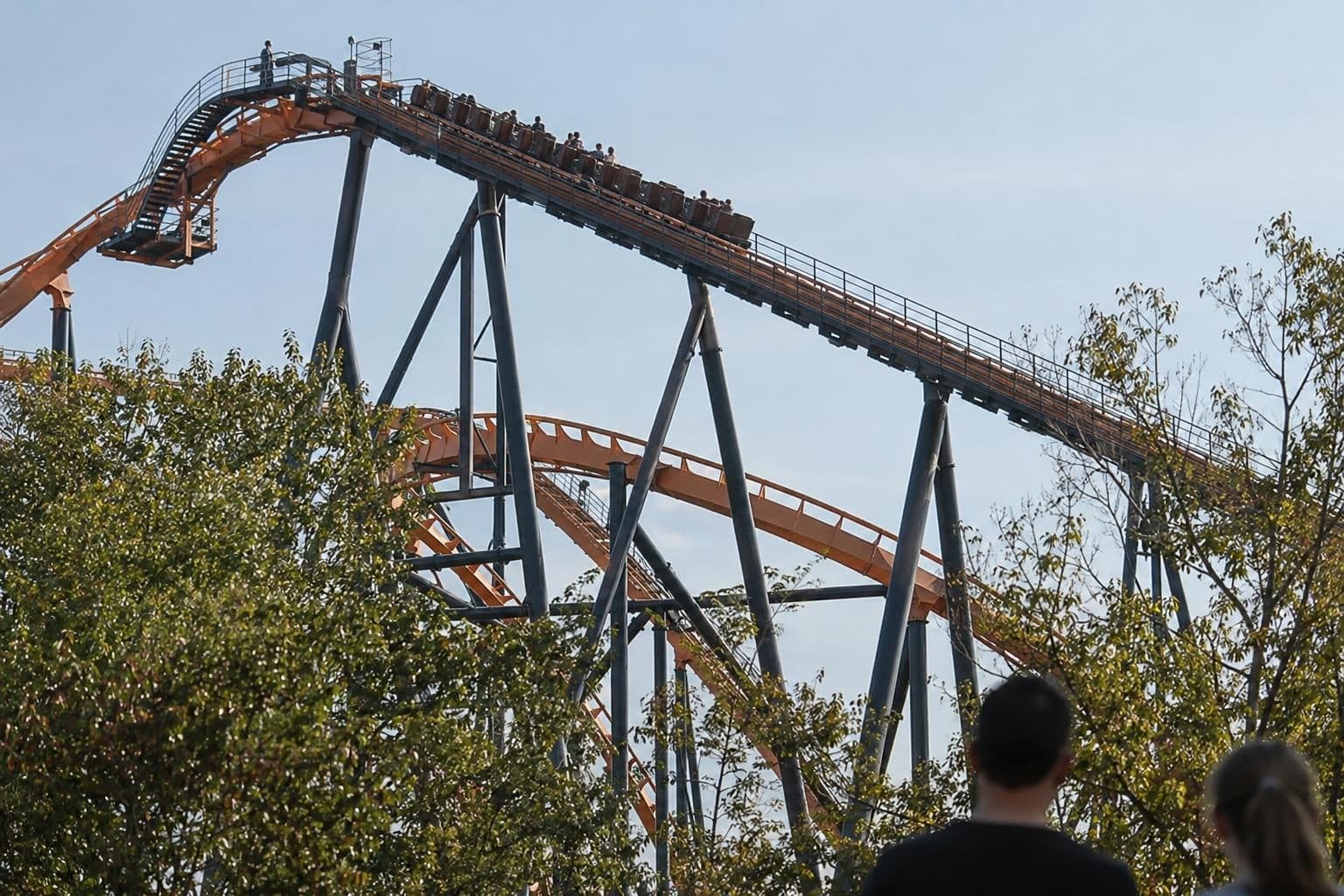 An elevated roller-coaster track and train at an amusement park